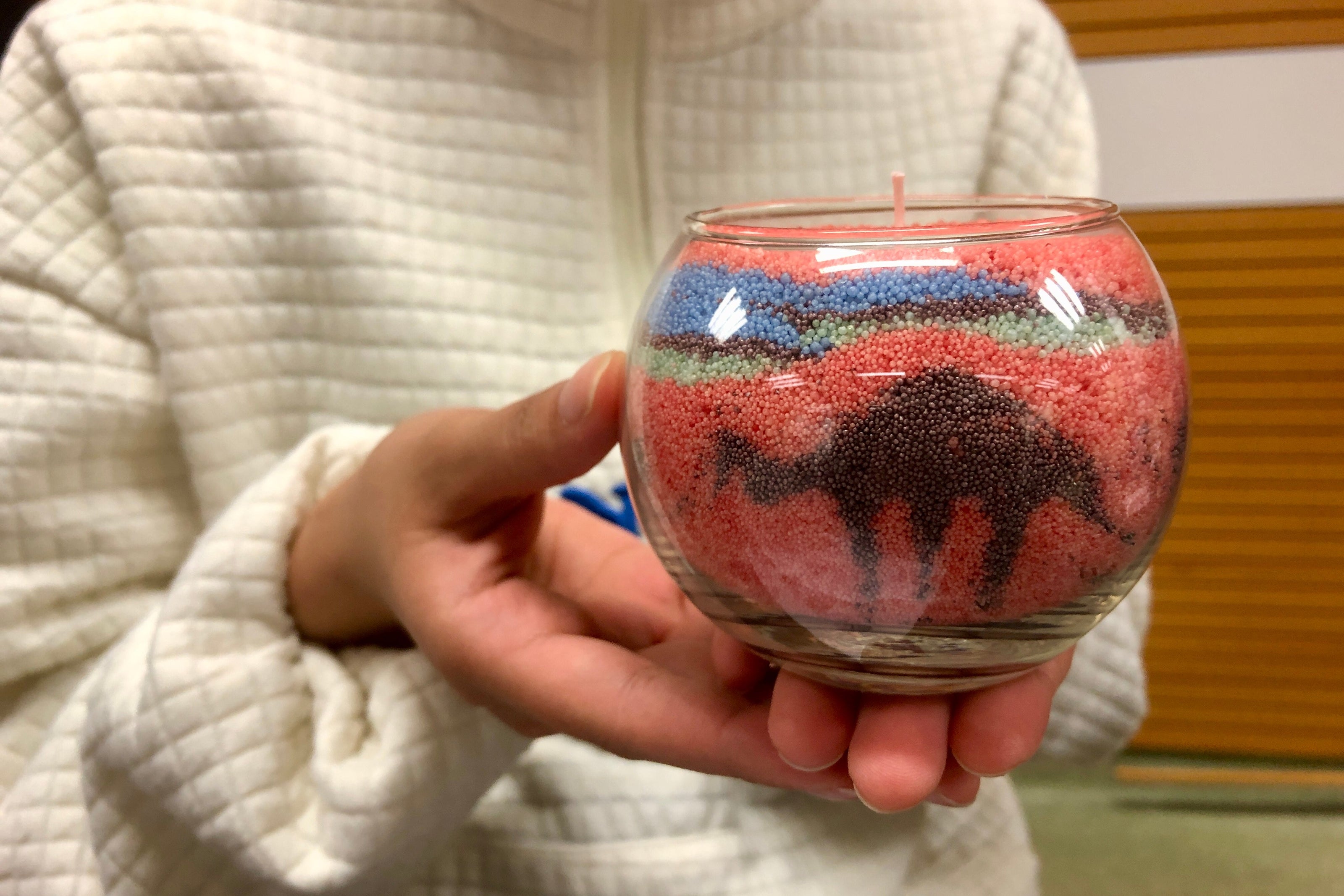 Students crafting sand art candles at an after class activity.