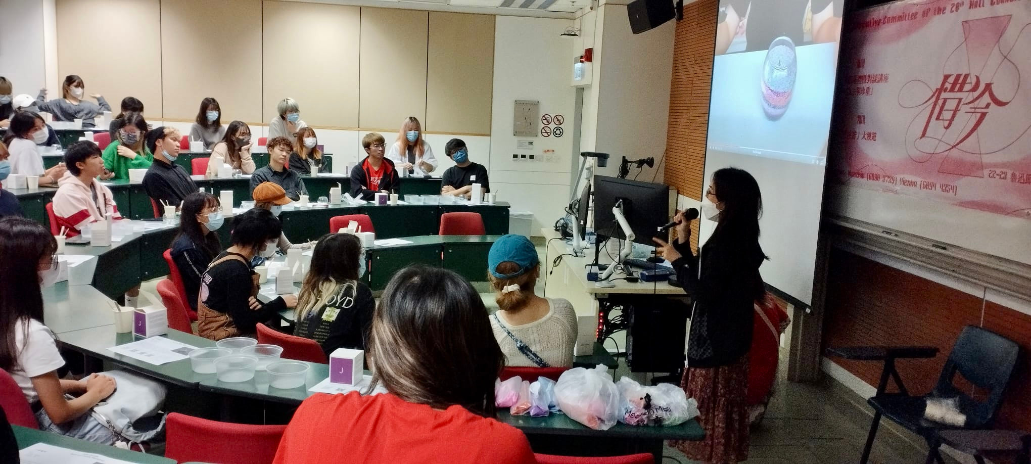 Students and volunteers making candles in a bright classroom setting