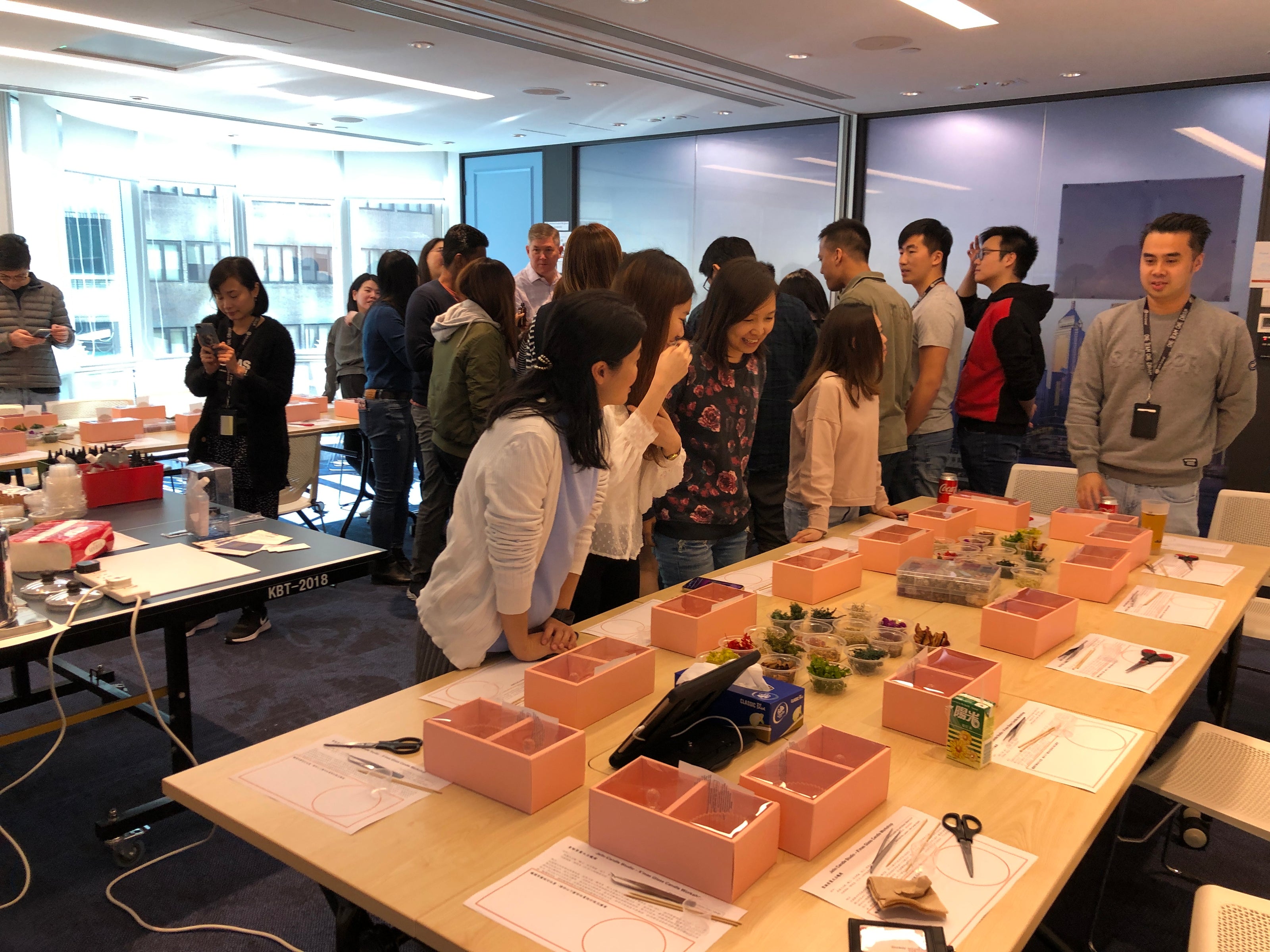 Team enjoying wine and wax candle-making during a corporate event