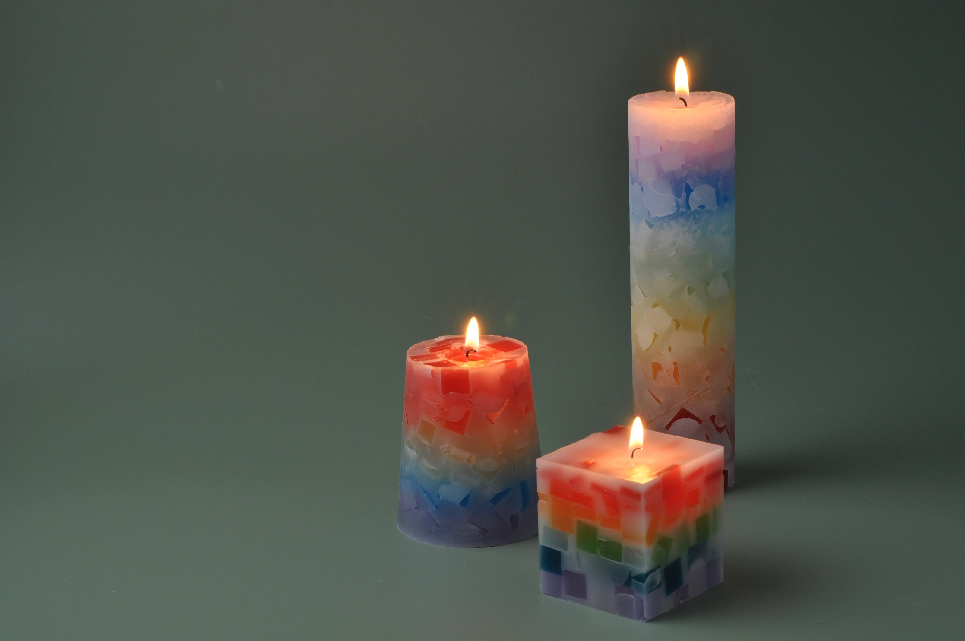 Assorted custom candles in different fragrances, wax types, and shapes